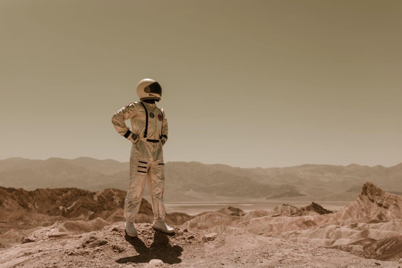 astronaut standing in desolate environment