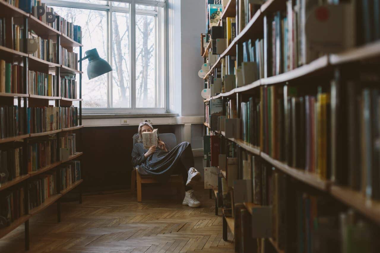 woman reading a book in a library